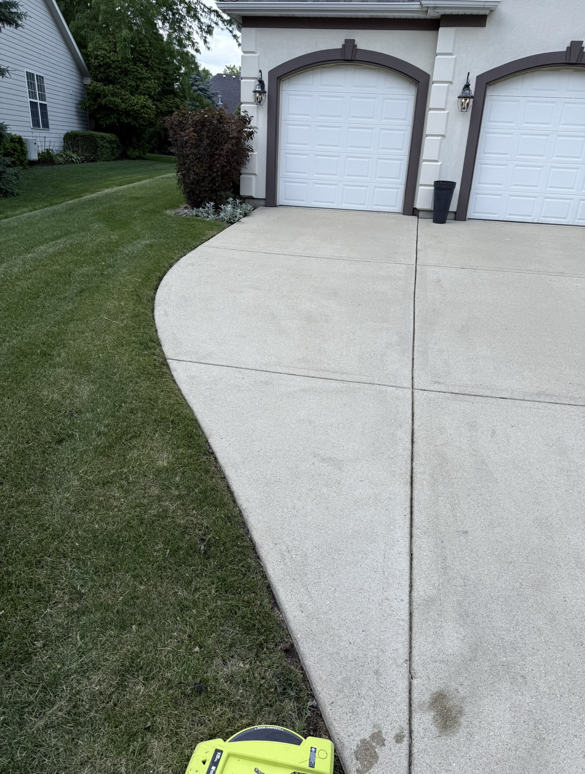 Driveway after cleaning approaching arched garage doors